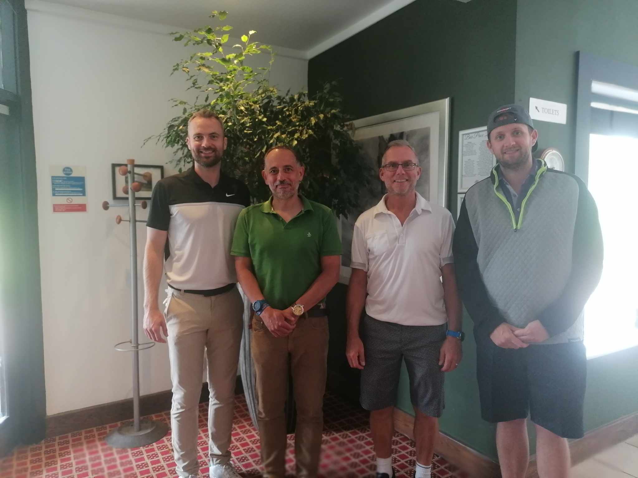 Golfers smiling in the club house bar