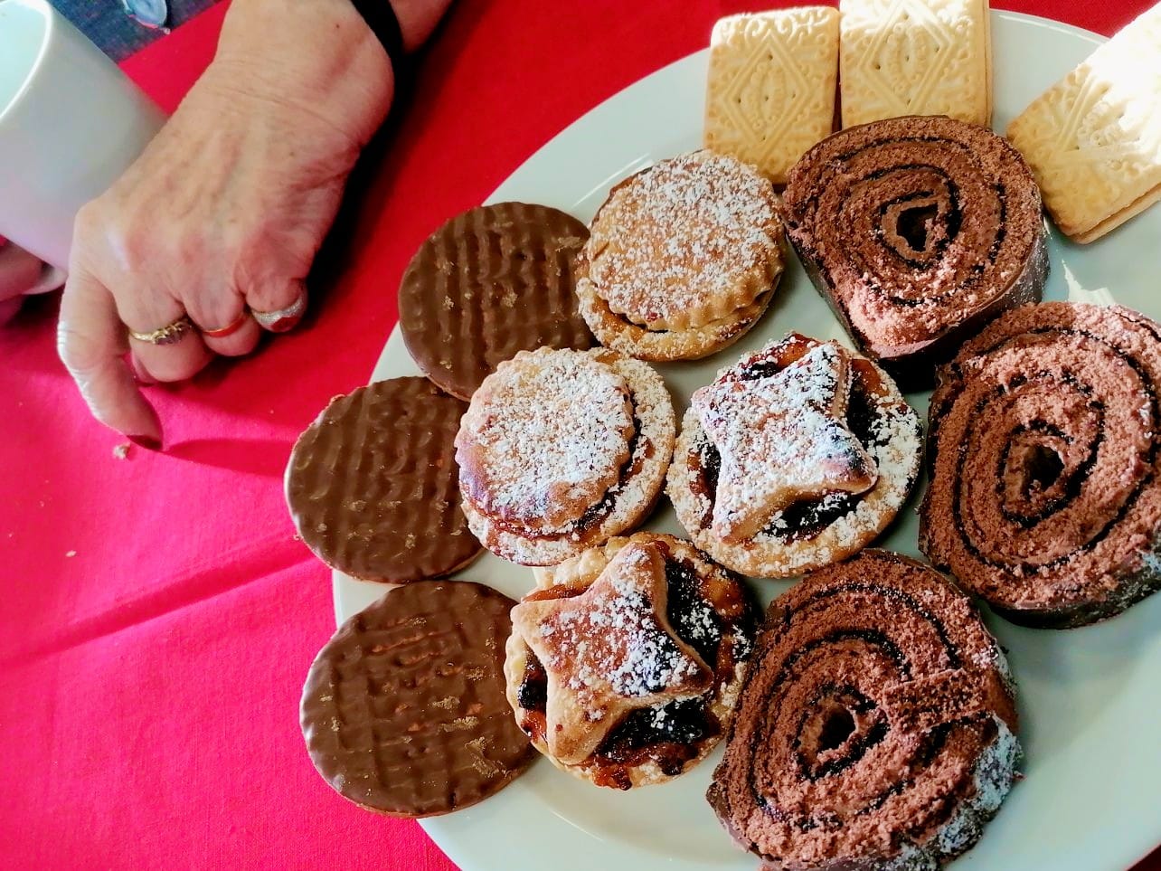 Mince pies, freshly made in Corton House kitchen, and biscuits on a plate.