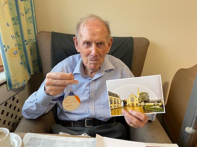 Corton House Care Home resident in Norwich with card and christmas decoration