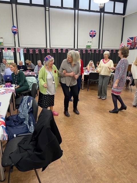 A group of older people in norfolk dancing at Age UK's royal celebration event