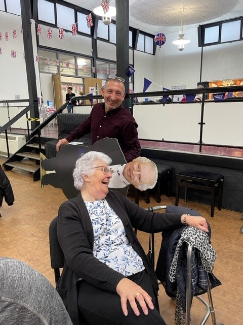 Care home manager Jason laughs and jokes with resident Norma.