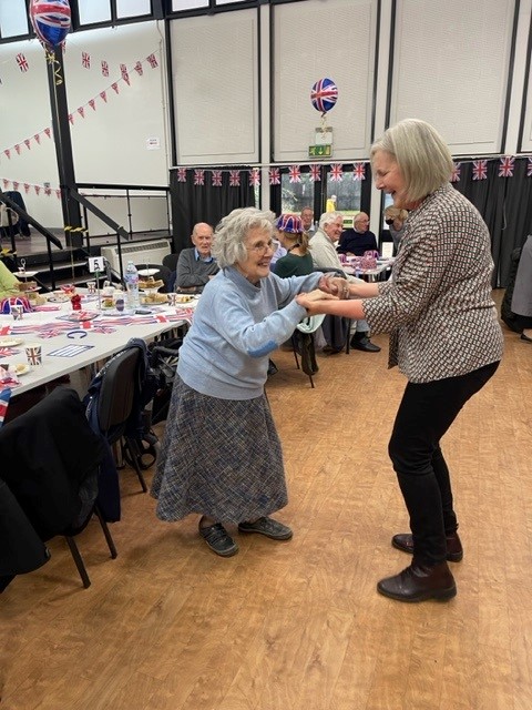 A Norwich care home resident dances with the Activities Coordinator at a party