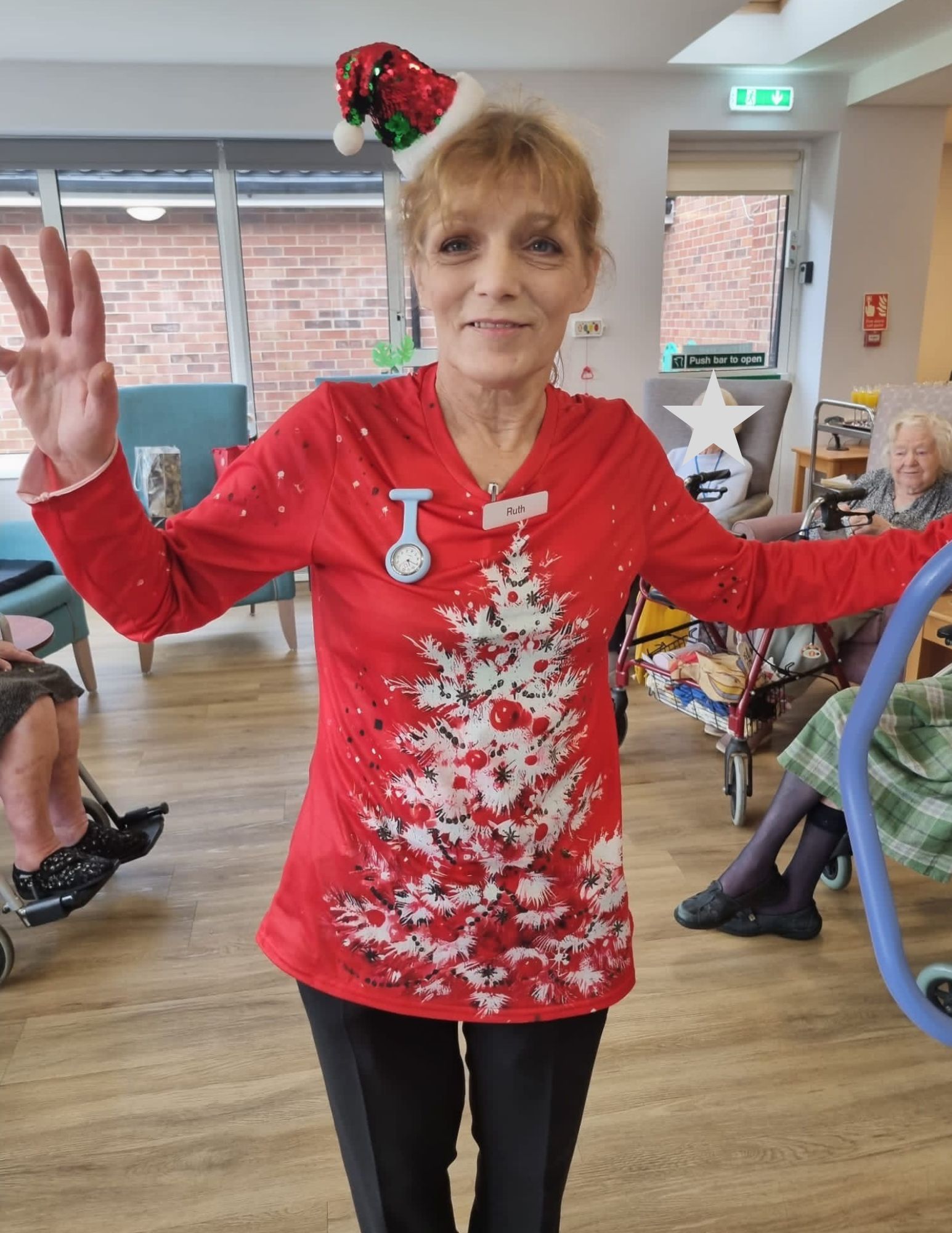 A staff member wears a Christmas jumper in the main lounge at Corton House