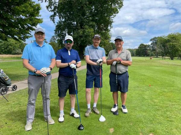 A team at Corton House golf day smiling on the golf course