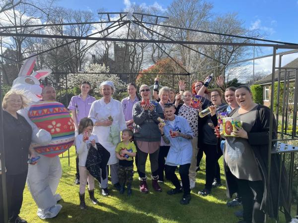 Staff enjoy an egg hunt in the garden at Corton House care home in Norwich.