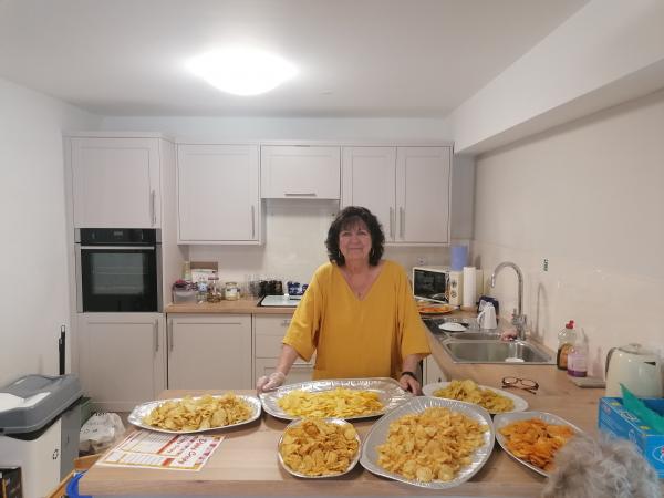 Scheme Manager Lorraine in the Brakendon Close kitchen with crisps