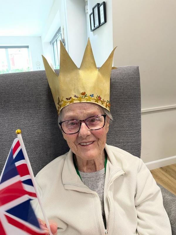 A resident at Corton House care home smiling and wearing a crown