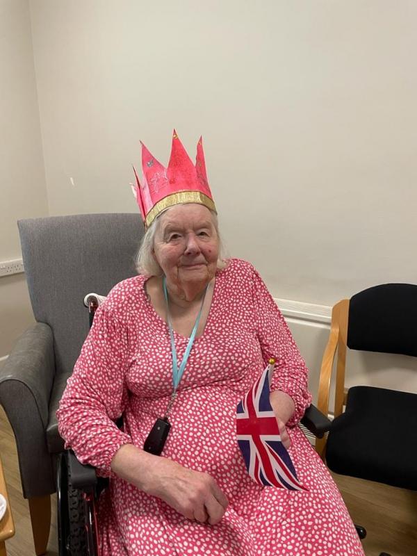 A happy resident in Corton House care home dressed up for the Coronation