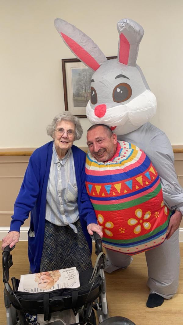 A smiling residentand care home manager Jason Parker dressed as the Easter Bunny