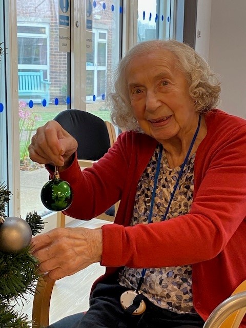 A Norwich care home resident decorates the Christmas Tree at Corton House