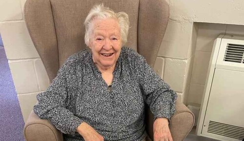 Norwich care home resident with hand knitted baby hats